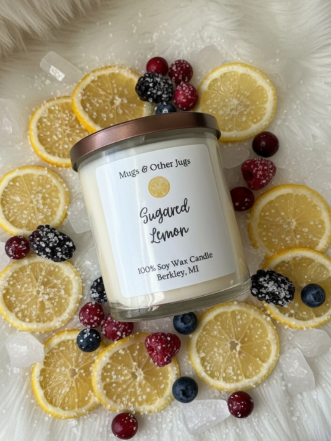 Sugared Lemon Candle with lemons and berries around it
