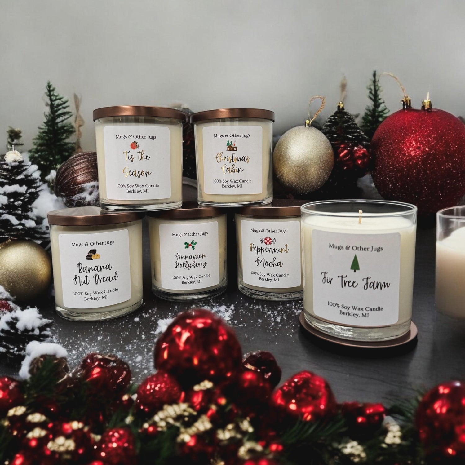holiday candles surrounded by ornaments that are red and gold