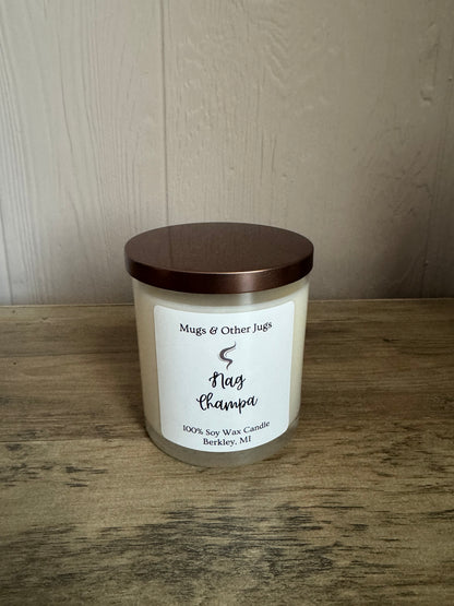Candle with a wooden lid on a wooden surface