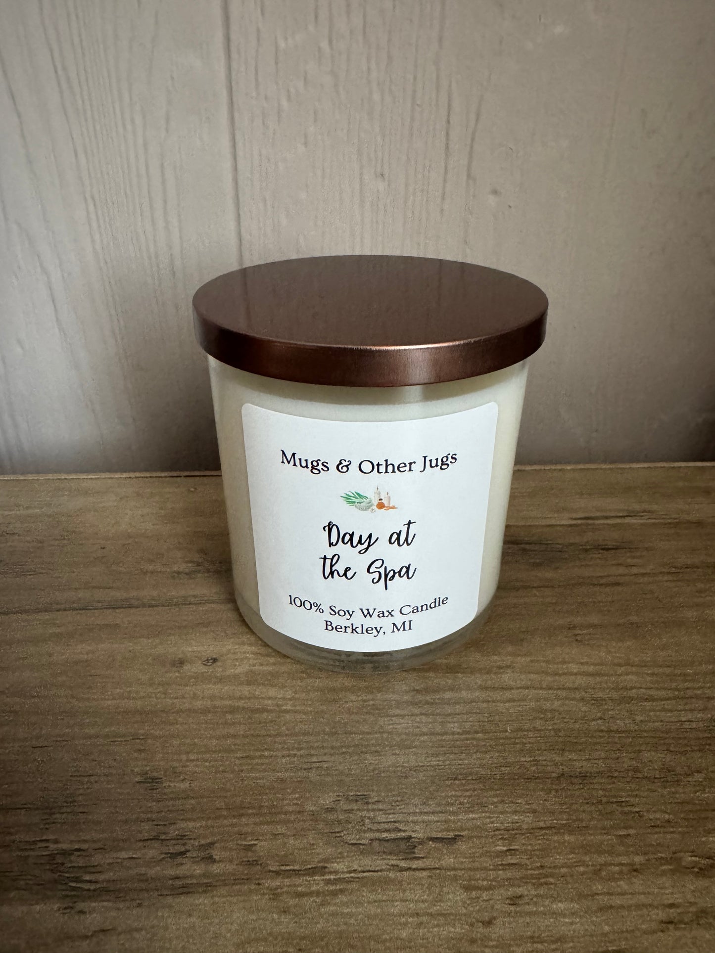 Candle with a label on a wooden surface