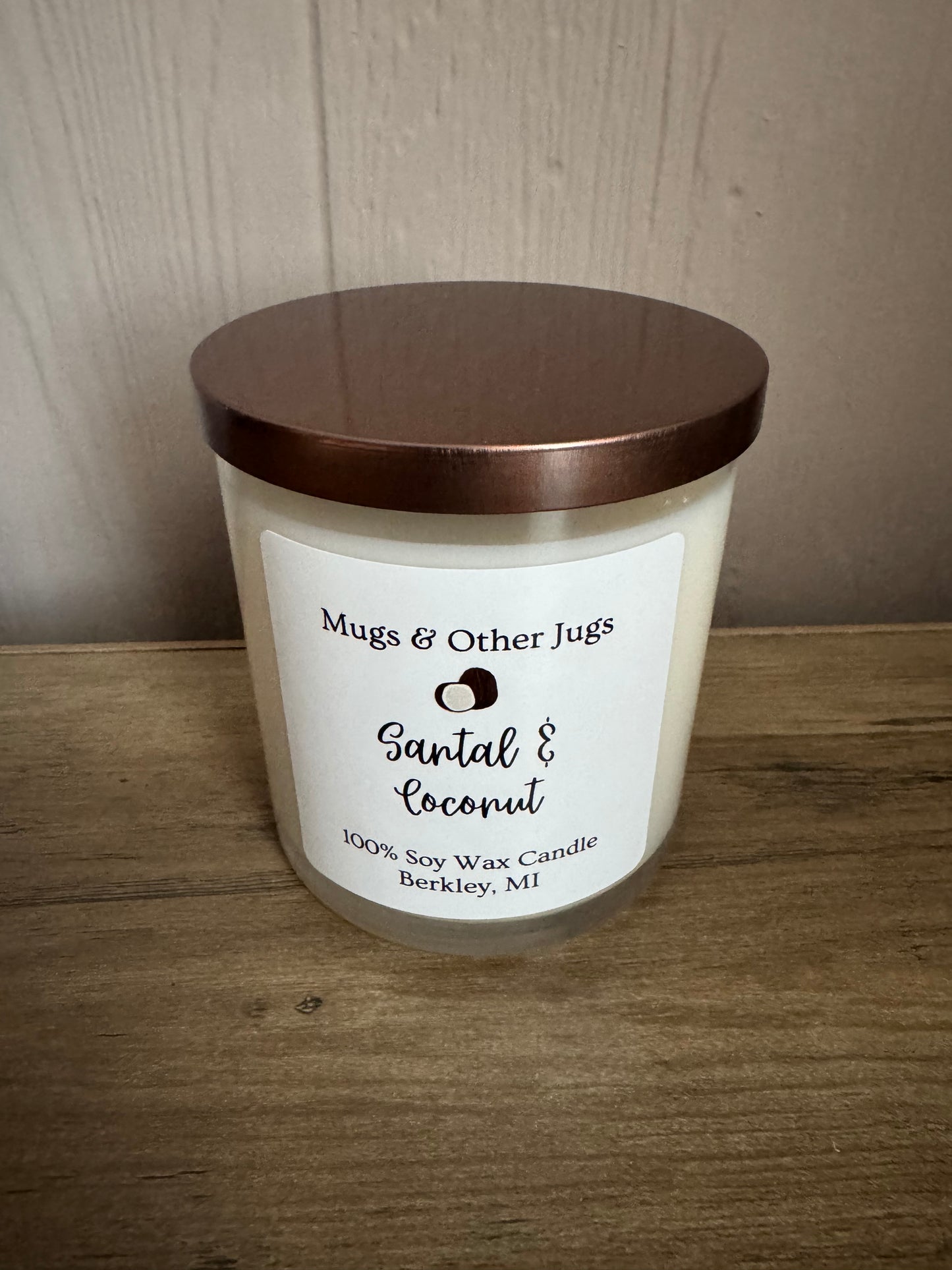 Candle with a label on a wooden surface