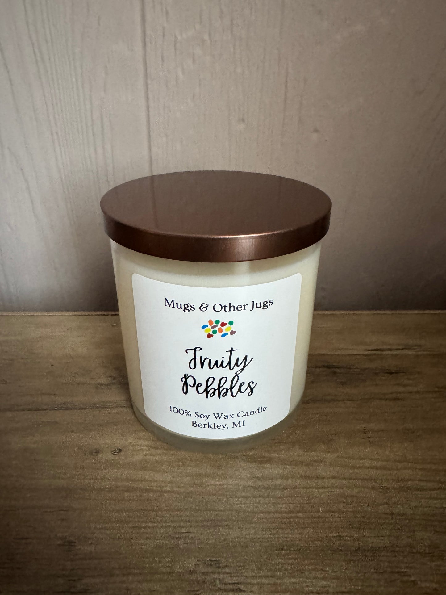 Candle with a label on a wooden surface