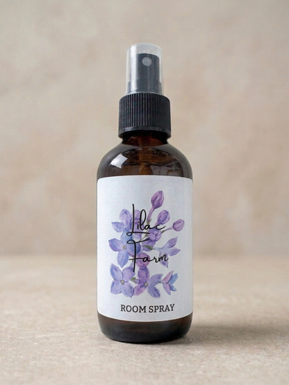 Room spray bottle with a label featuring purple flowers on a beige background