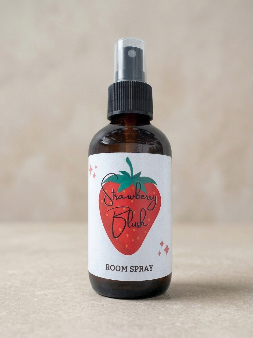 Room spray bottle labeled 'Strawberry Blush' on a beige background